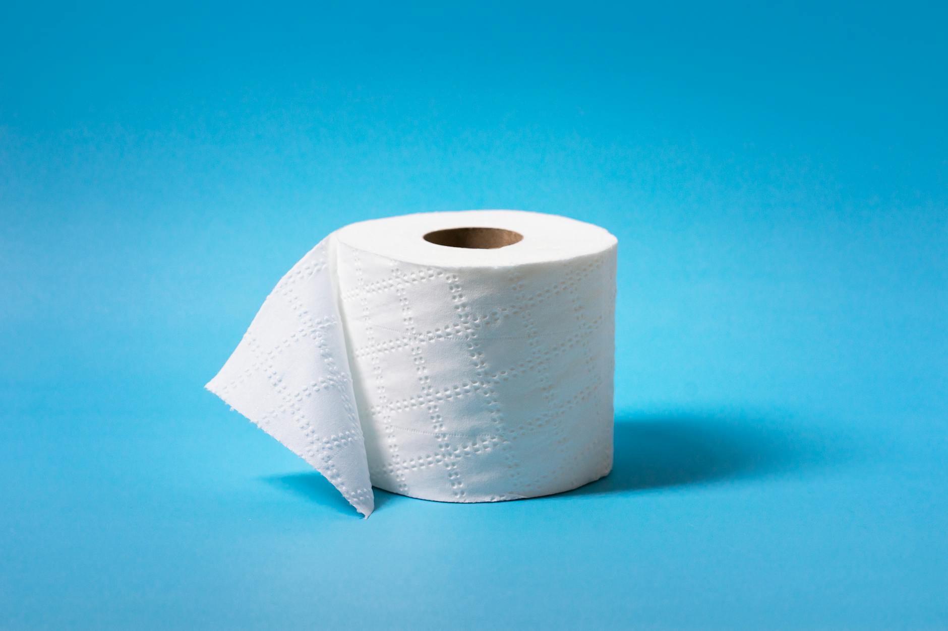Rolka papieru toaletowego na niebieskim tle