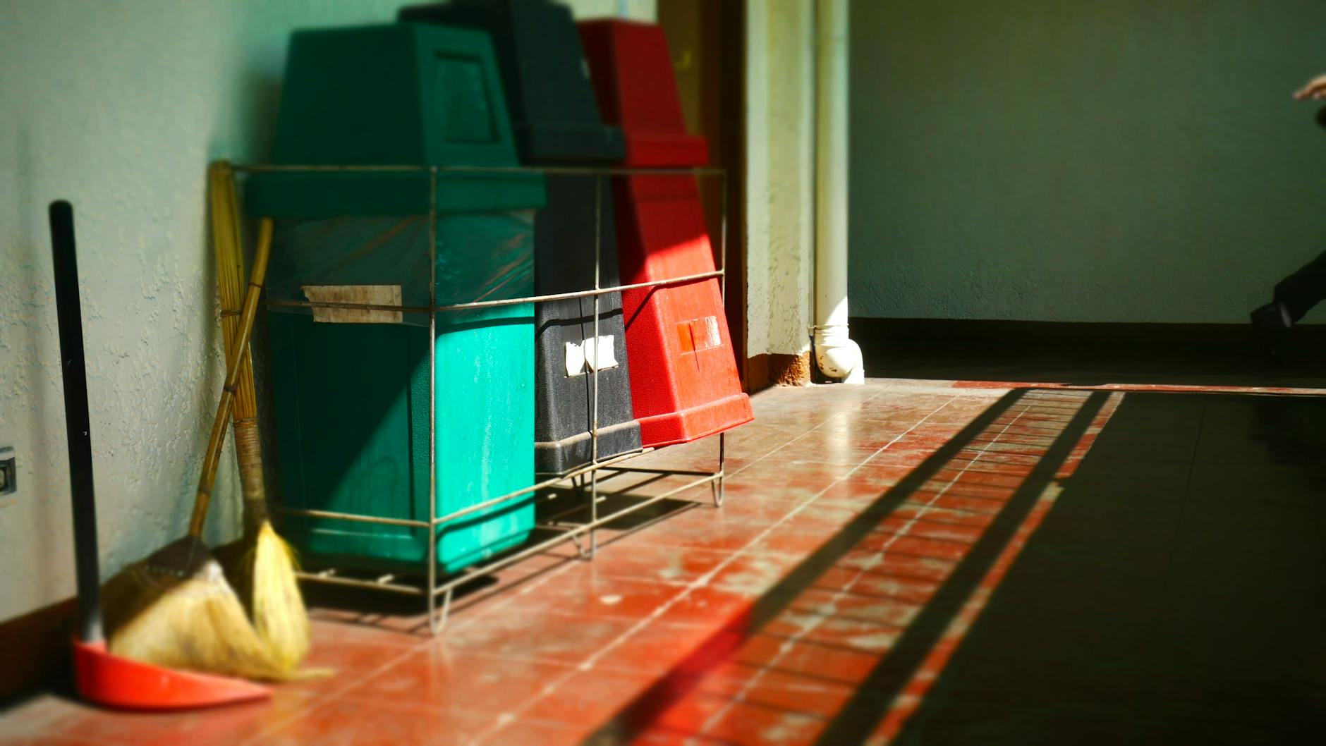 Wózki z workami na odpady i mopy w jasnym biurowym korytarzu