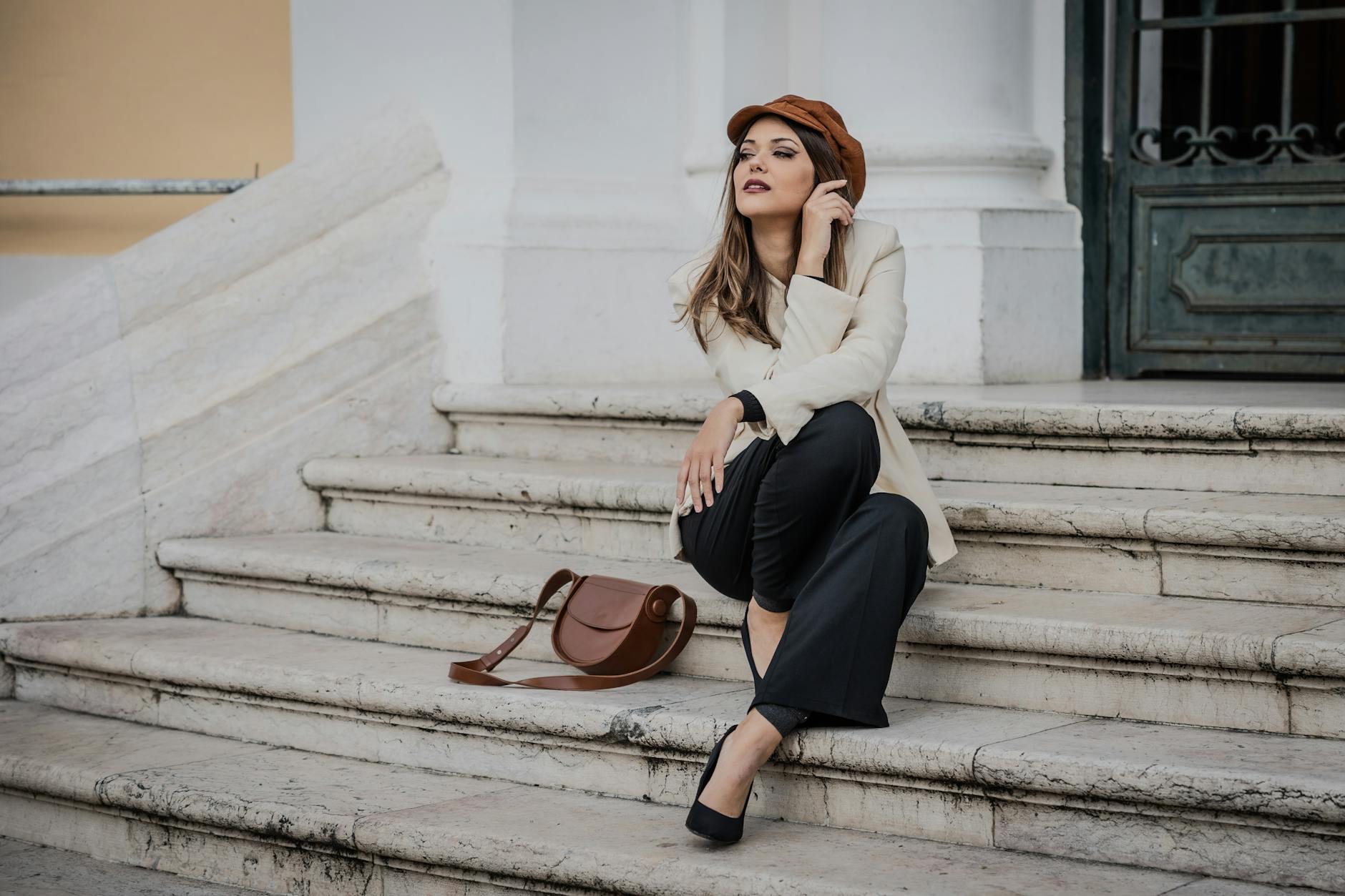 Elegancka kobieta w klasycznym stroju pozuje na ulicy w Lizbonie
